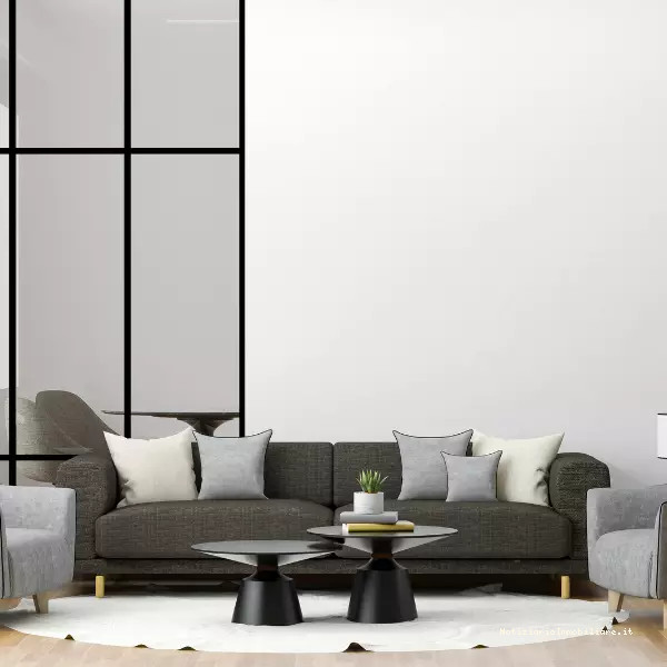 arredamento soggiorno con divano e poltrone sui toni del grigio