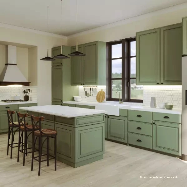 Cucina con isola illuminata da lampade a sospensione