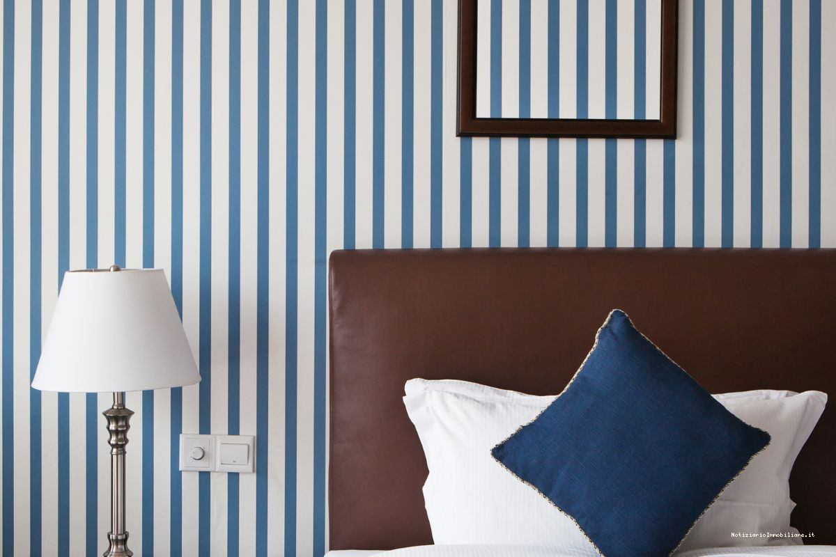parete dietro letto matrimoniale a righe verticali blu e bianche